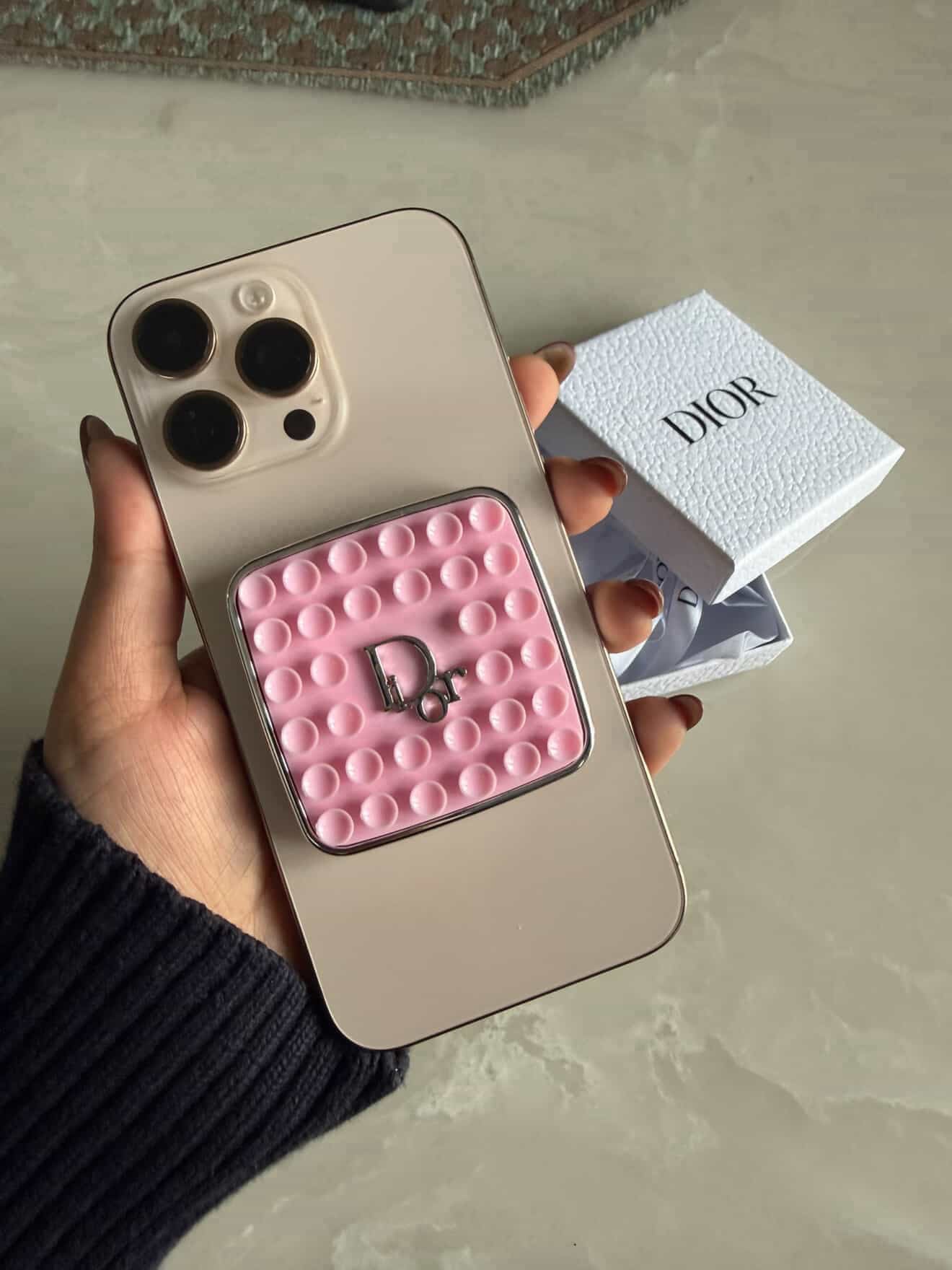 Dior Pink Phone Grip on a phone